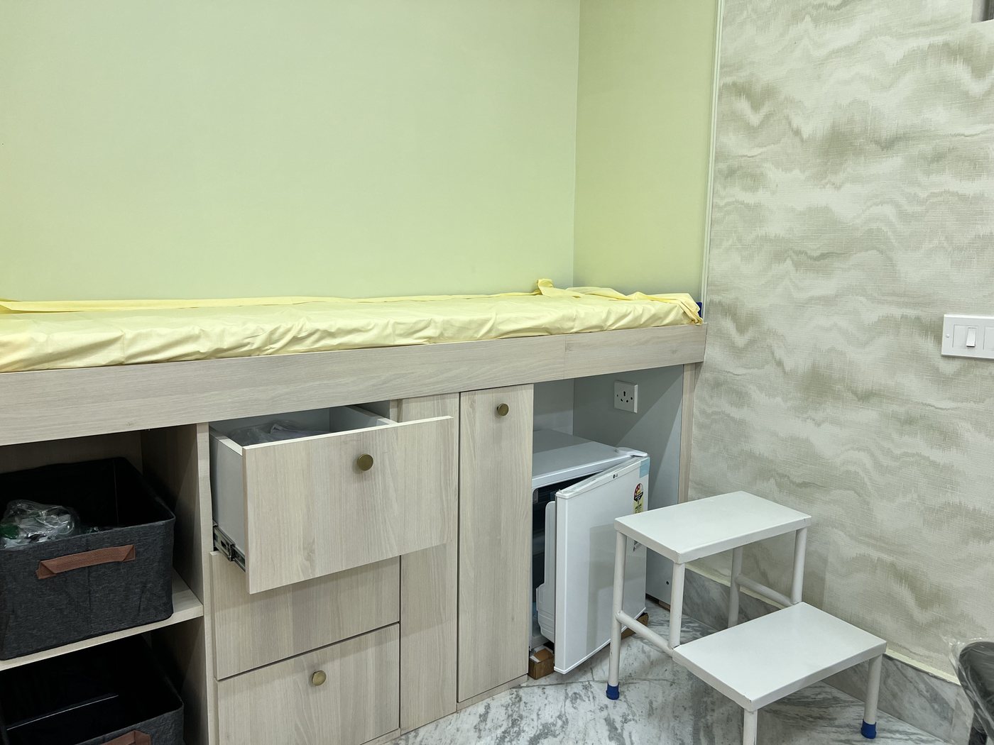 Drawers and the small fridge under the counter
